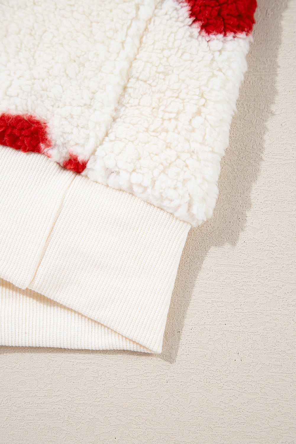 Fiery red heart motif on cozy white fleece sweatshirt with crewneck drop-shoulder and ribbed cuff.